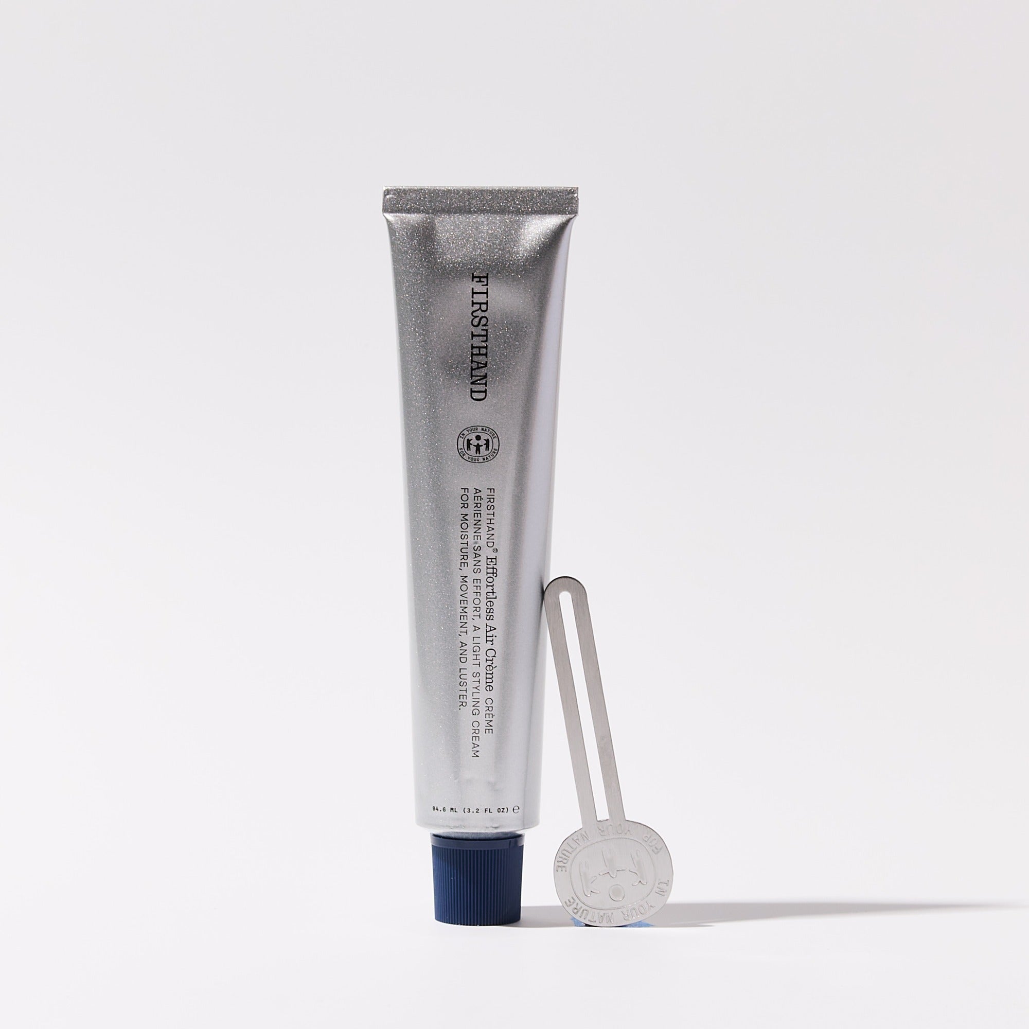 The squeeze key standing next to a tube of Effortless Air Crème